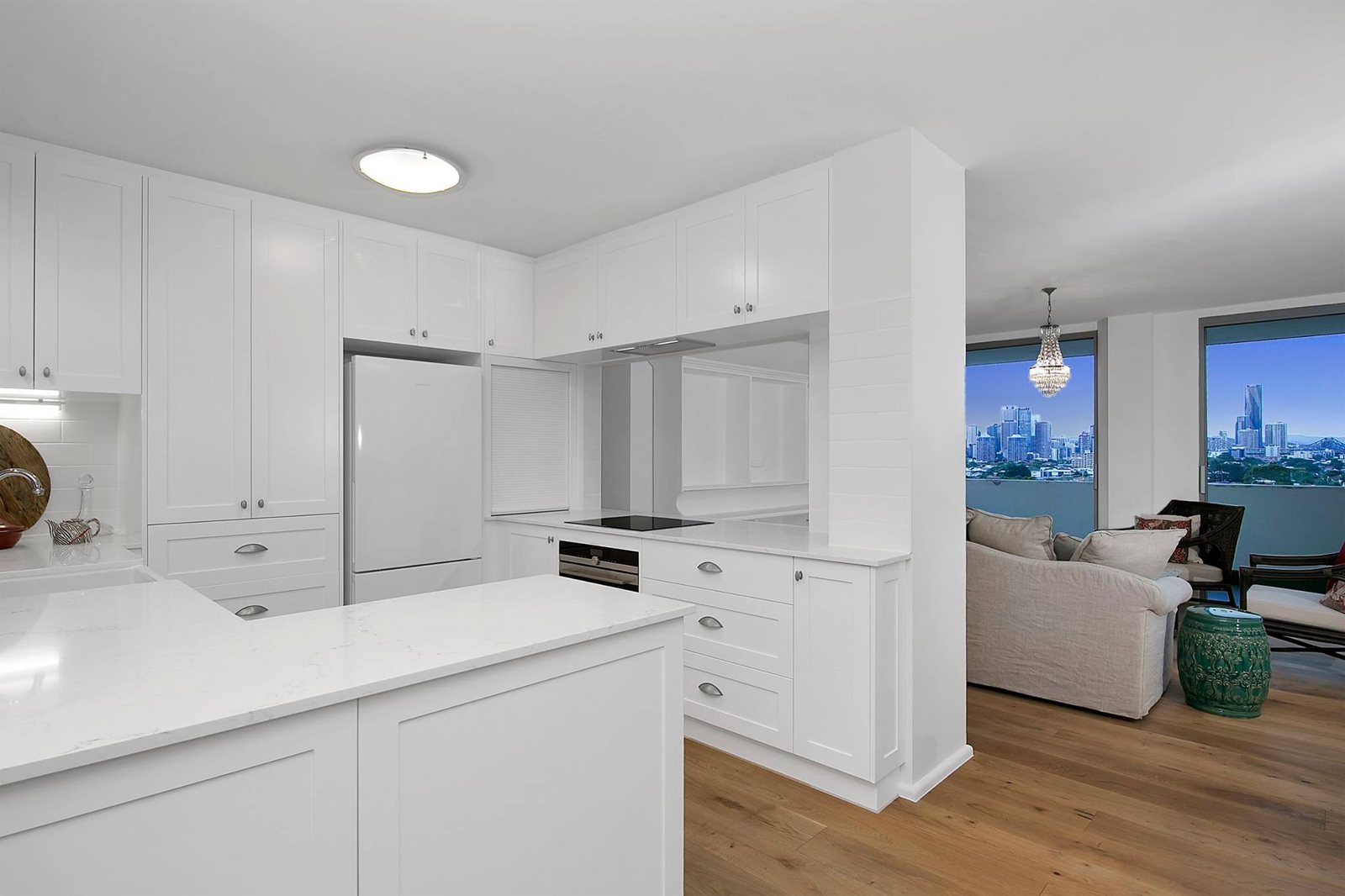 Living area after: open shaker kitchen, timber floors and city views