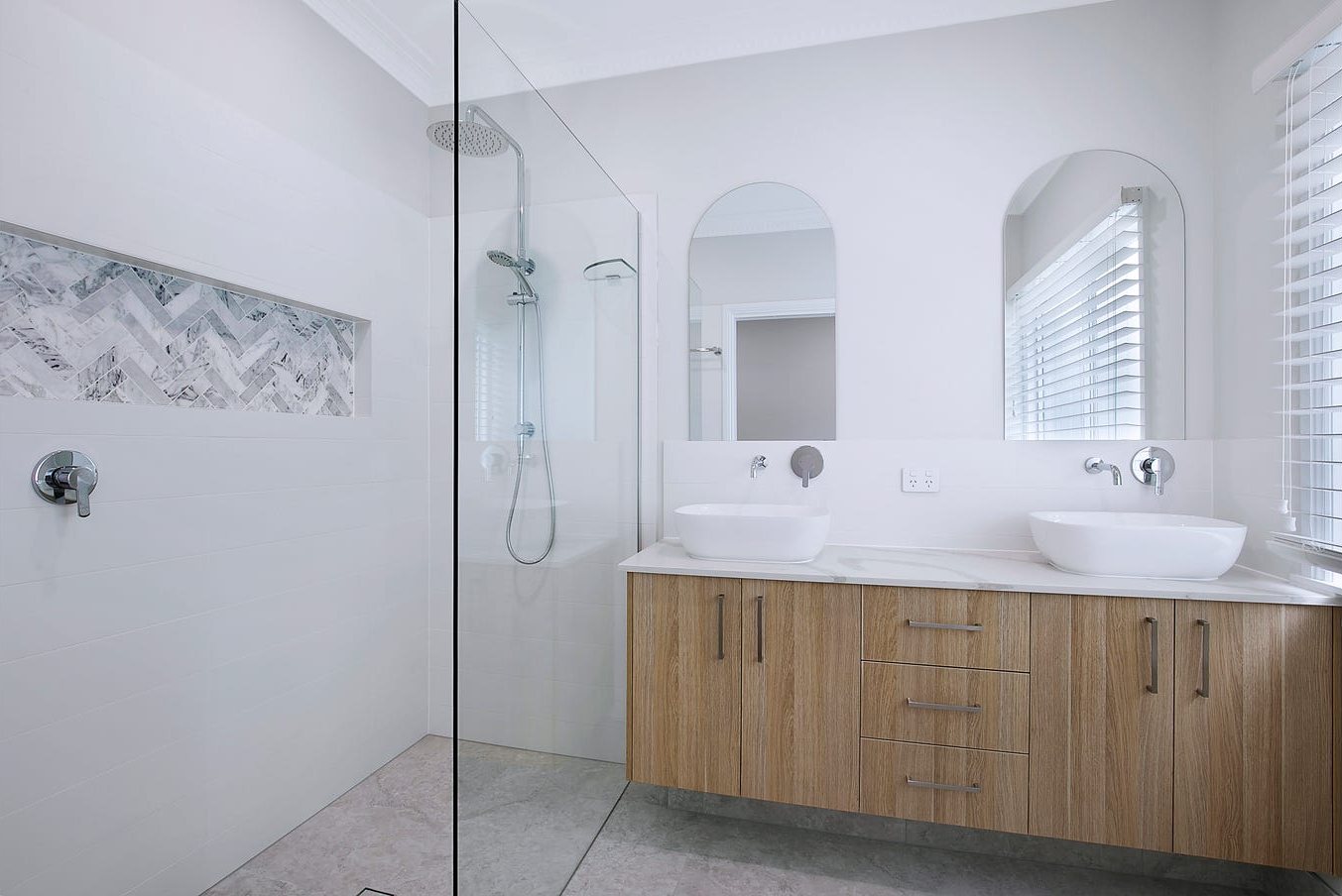Bathroom with timber double vanity, arched mirrors and walk-in shower