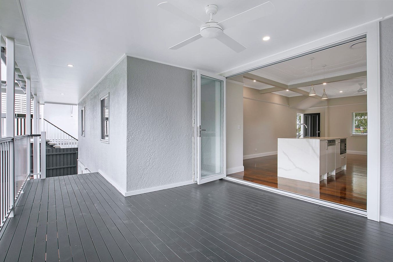 Covered rear deck opening to the kitchen through bifold doors