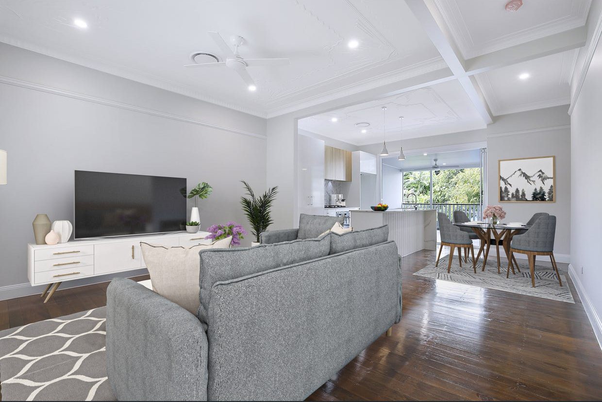 Open-plan living and dining under restored pressed-metal ceilings