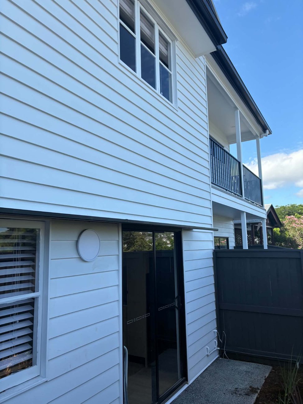 Rear of the duplex with weatherboard cladding and balcony