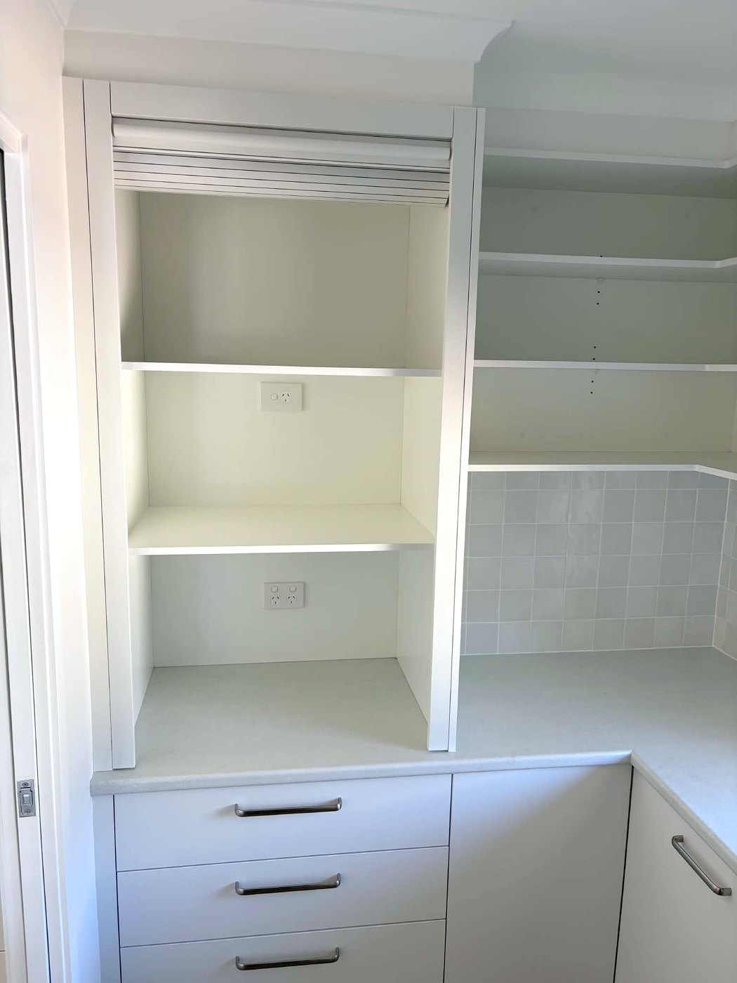 Butler's pantry with roller-door appliance cupboard and power points