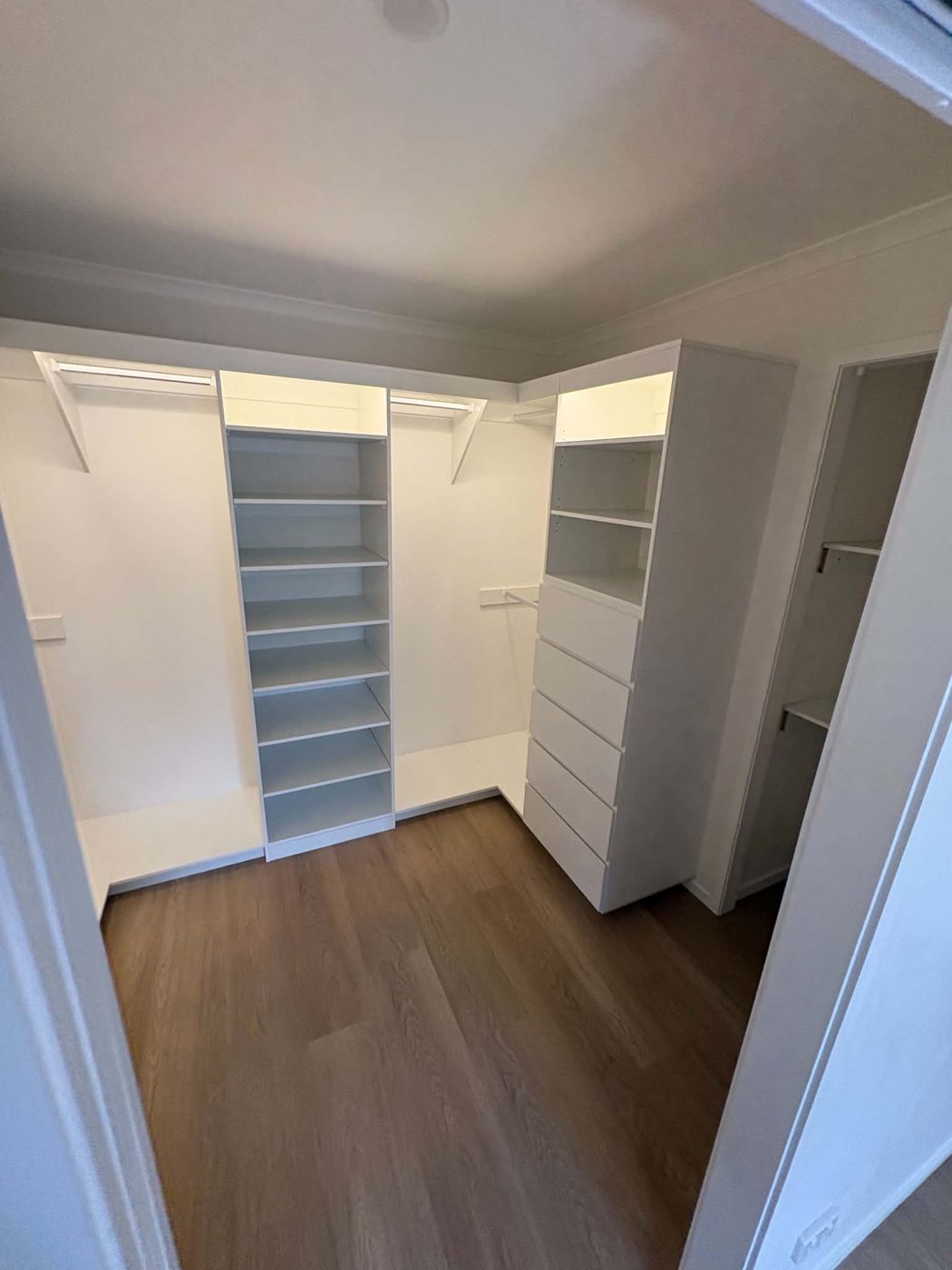 Walk-in robe with shelving towers, drawers, hanging rails and LED lighting